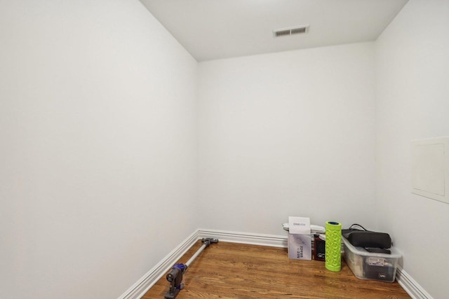 laundry area with hardwood / wood-style flooring