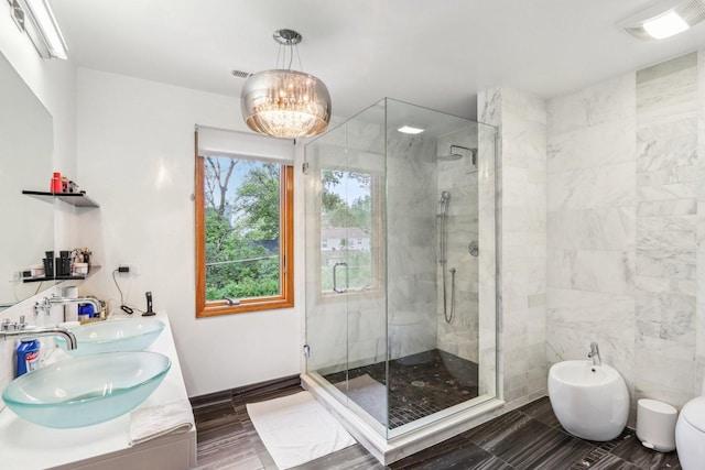 bathroom with vanity, hardwood / wood-style flooring, a bidet, a chandelier, and a shower with shower door