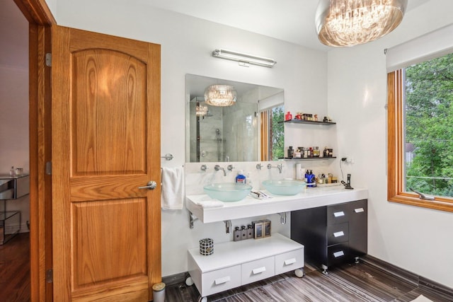 bathroom featuring vanity, a wealth of natural light, hardwood / wood-style floors, and a shower