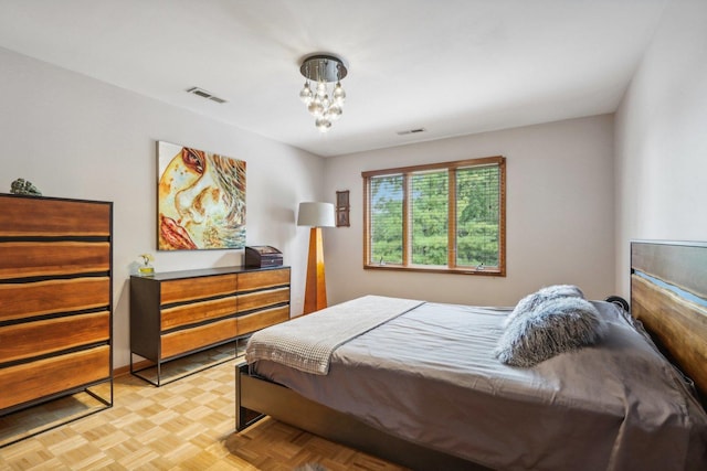 bedroom with light parquet floors