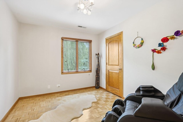 living area featuring a chandelier and light parquet floors