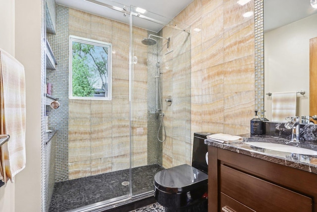 bathroom with vanity and a shower with door