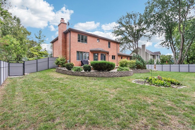 rear view of property featuring a yard