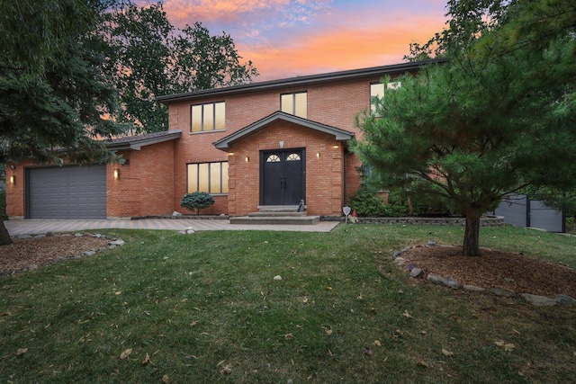 view of front property with a garage and a lawn