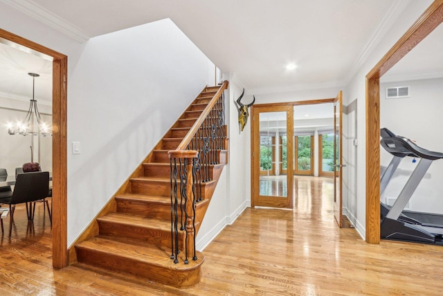 entrance foyer featuring french doors, light hardwood / wood-style floors, and ornamental molding