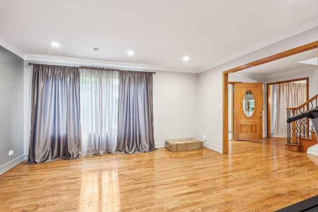 unfurnished living room featuring crown molding and light hardwood / wood-style flooring