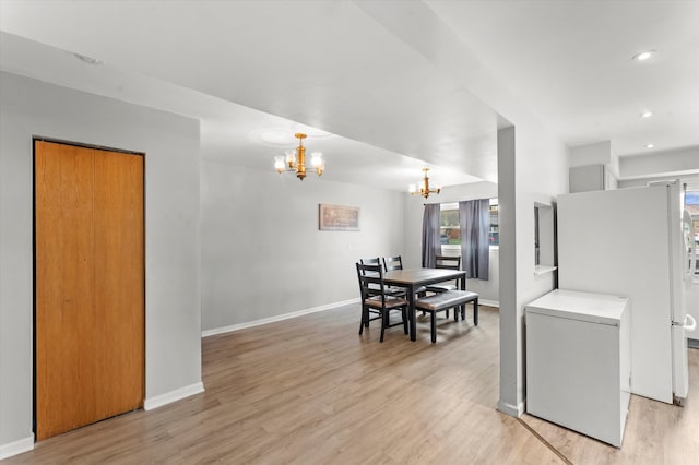 interior space featuring a chandelier and light wood-type flooring