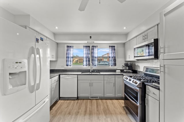 kitchen featuring gray cabinetry, stainless steel appliances, ceiling fan, sink, and light hardwood / wood-style floors