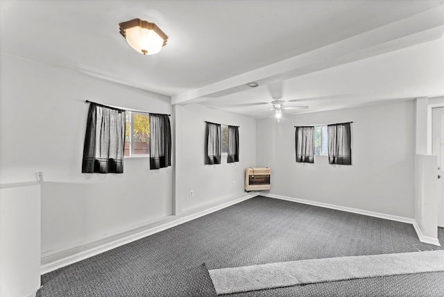 carpeted spare room featuring heating unit and ceiling fan