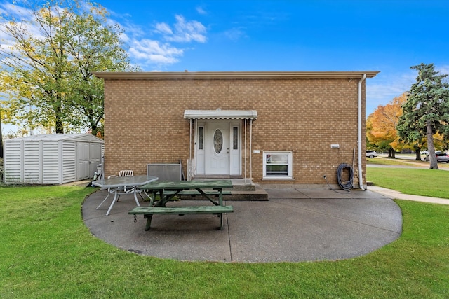 back of house featuring a storage shed, a yard, and a patio