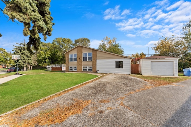 view of front of property with a front yard, a garage, and an outdoor structure