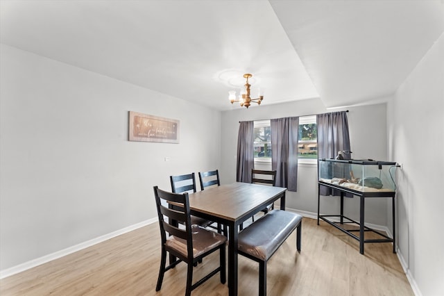 dining area featuring light hardwood / wood-style floors and a chandelier