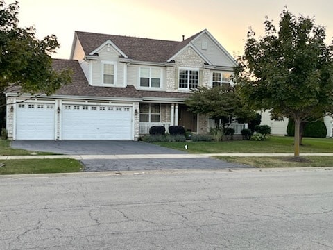 view of front of home with a lawn and a garage