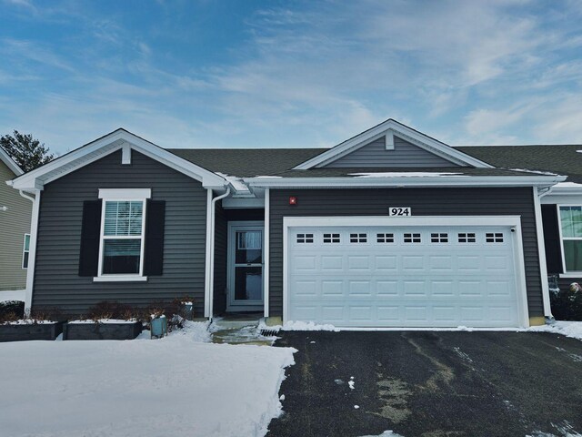 ranch-style house with a front lawn and a garage