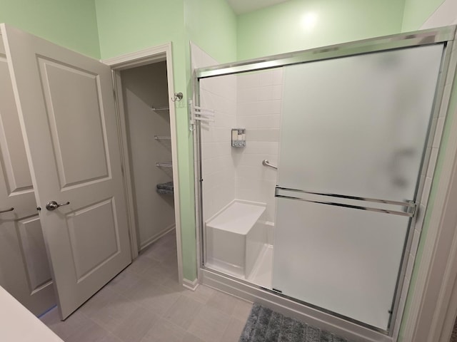 bathroom featuring a shower with door