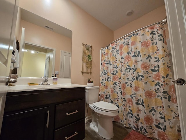 bathroom with vanity, toilet, and curtained shower