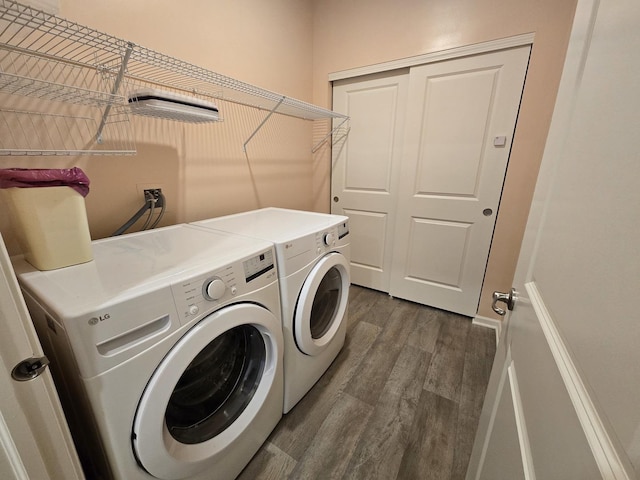 laundry area featuring dark hardwood / wood-style flooring and washer and clothes dryer