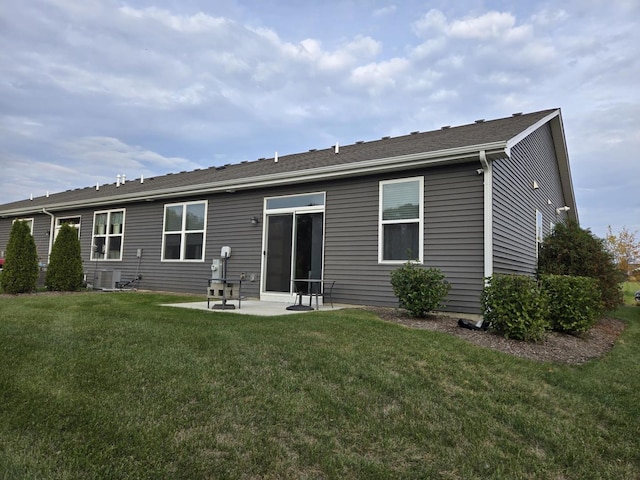 rear view of house featuring a patio area and a lawn