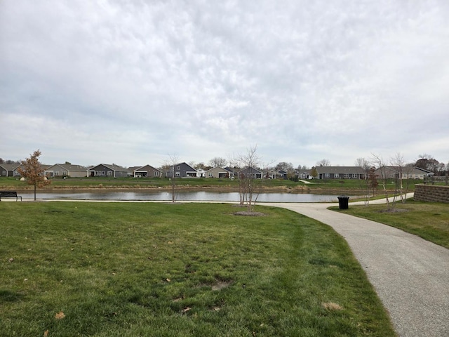 view of property's community featuring a water view and a lawn