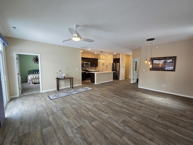 unfurnished living room featuring dark hardwood / wood-style floors and ceiling fan