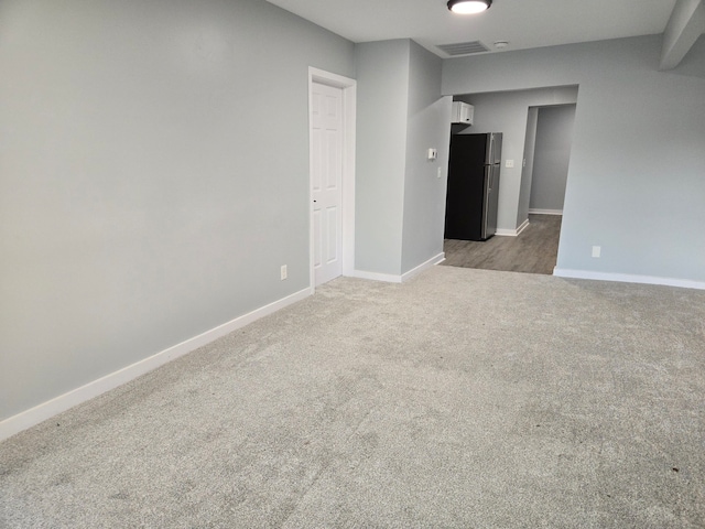 empty room featuring dark colored carpet