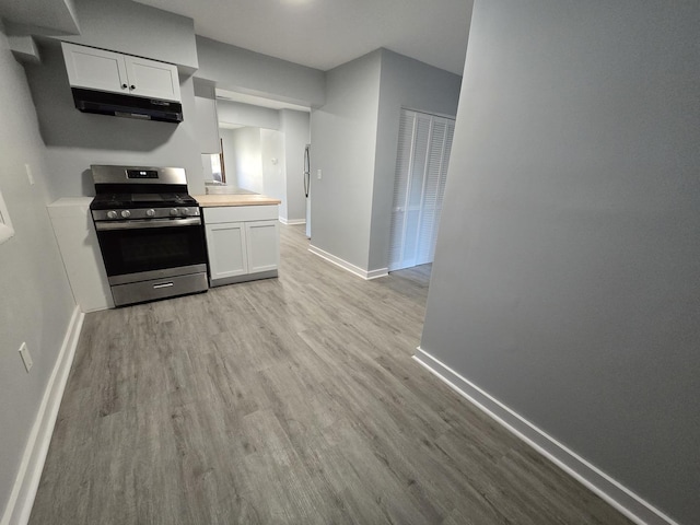 1007 River Rd, Mchenry, IL 60050 - kitchen with white cabinetry, baseboards, and gas range