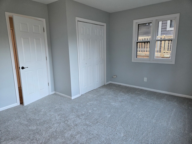 unfurnished bedroom featuring carpet and a closet