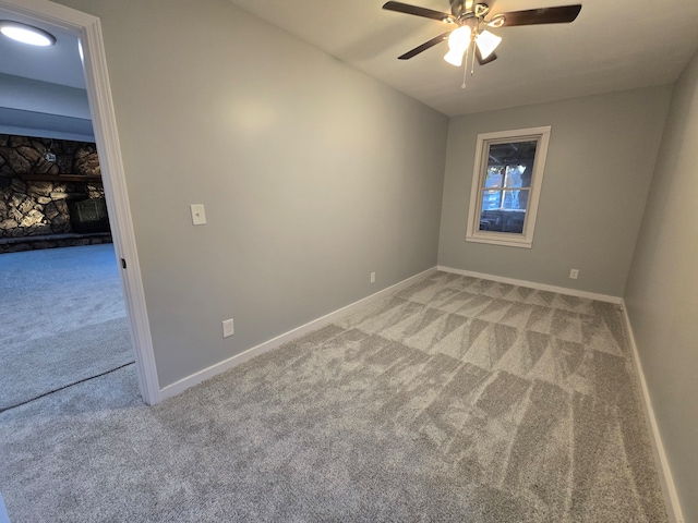 empty room featuring light colored carpet and ceiling fan