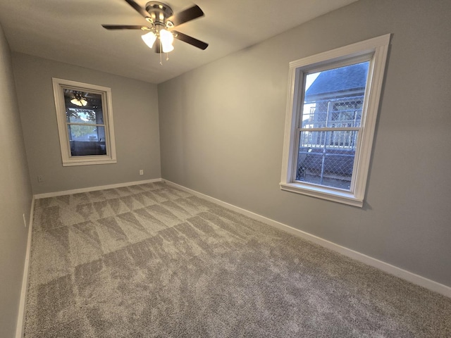 1007 River Rd, Mchenry, IL 60050 - spare room with baseboards, plenty of natural light, light carpet, and a ceiling fan