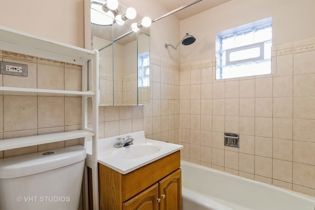 full bathroom featuring toilet, tiled shower / bath, tasteful backsplash, and vanity