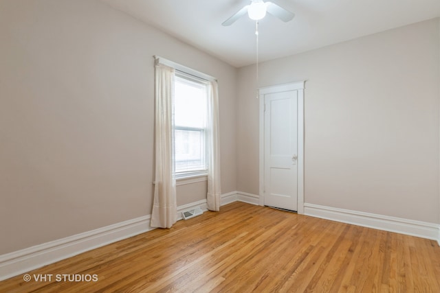 empty room featuring ceiling fan and light wood-type flooring