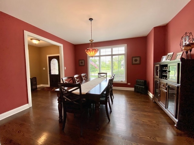 dining space featuring dark hardwood / wood-style floors