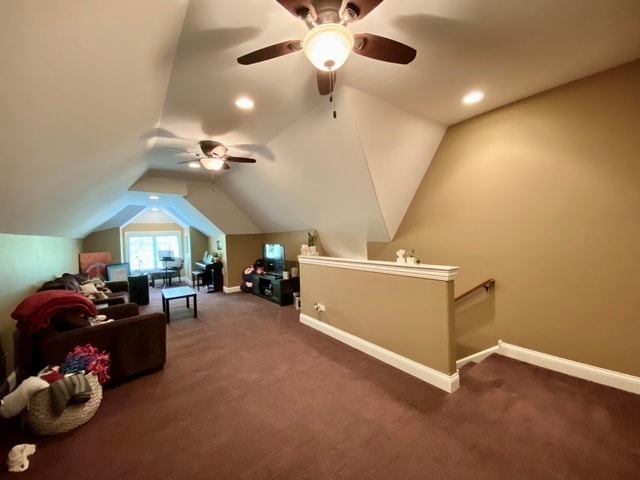 bonus room with vaulted ceiling, ceiling fan, and dark carpet