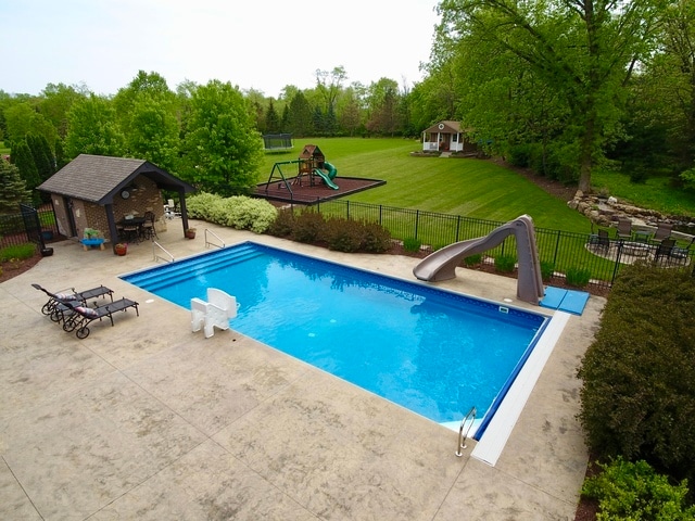 view of pool featuring a gazebo, a patio, a playground, a water slide, and a yard