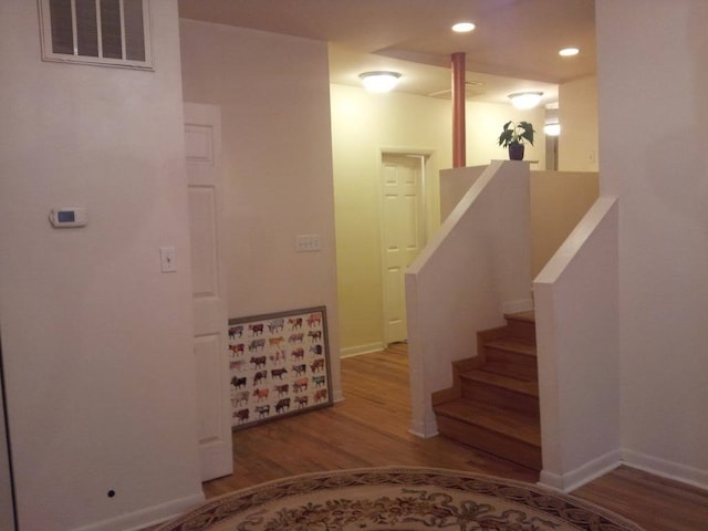 staircase with wood-type flooring