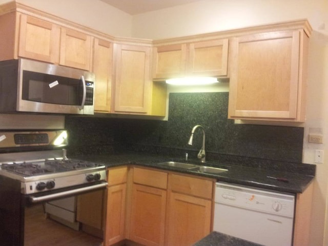 kitchen featuring sink, decorative backsplash, white appliances, and light brown cabinets