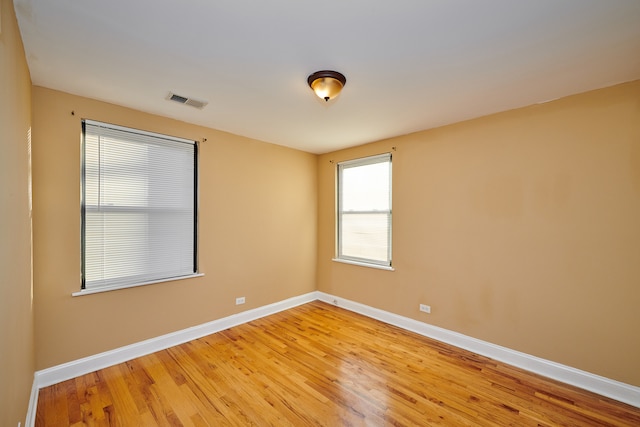 empty room with hardwood / wood-style floors