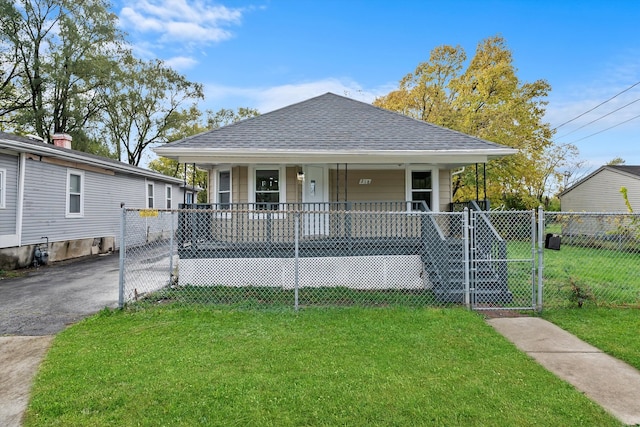 bungalow featuring covered porch and a front lawn