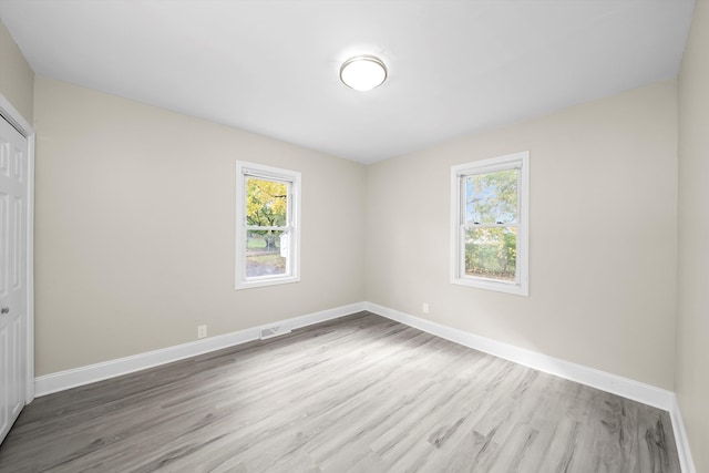 unfurnished room featuring hardwood / wood-style flooring