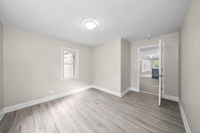 empty room with light wood-type flooring and a wealth of natural light