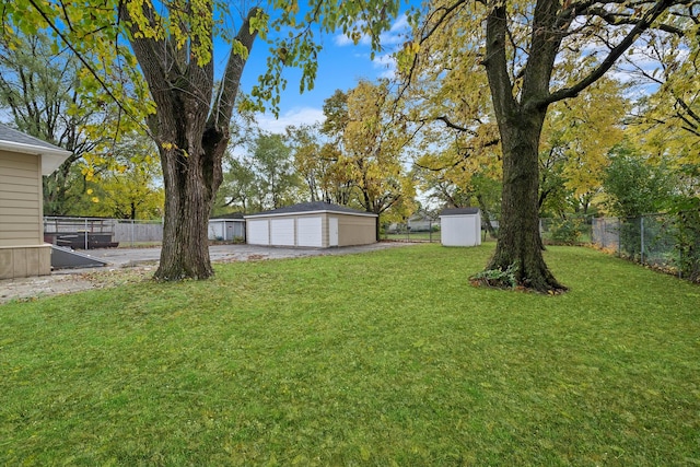 view of yard featuring a garage and an outdoor structure