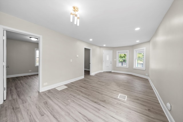 spare room featuring light hardwood / wood-style floors