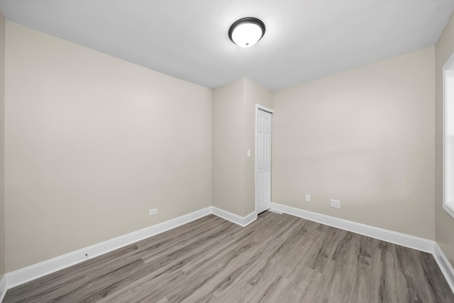 empty room with light hardwood / wood-style flooring