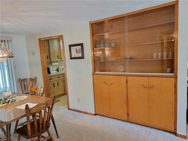 dining room with light colored carpet