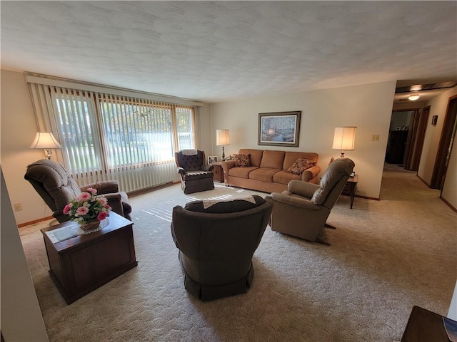 living room with a textured ceiling and light colored carpet