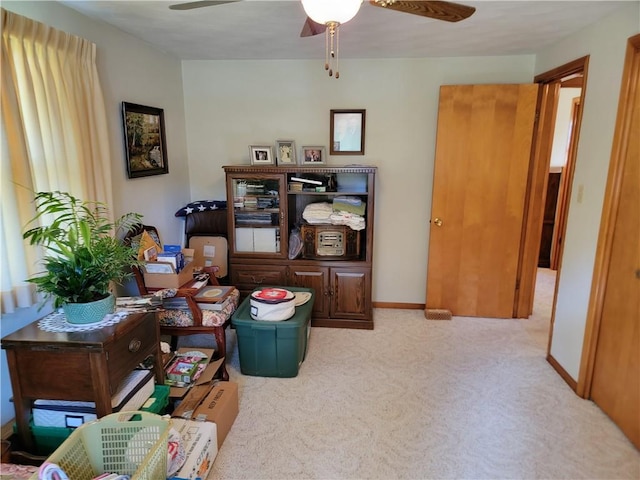 interior space with light carpet and ceiling fan