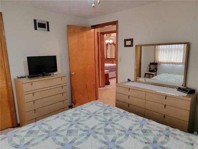 carpeted bedroom with ensuite bath