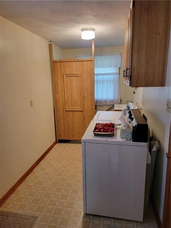 laundry area featuring cabinets