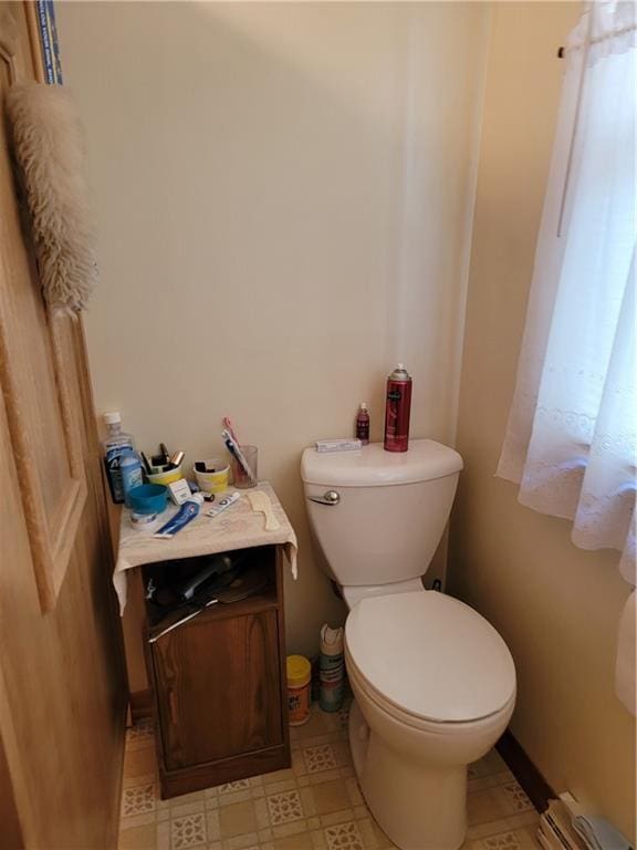 bathroom featuring toilet and a baseboard heating unit