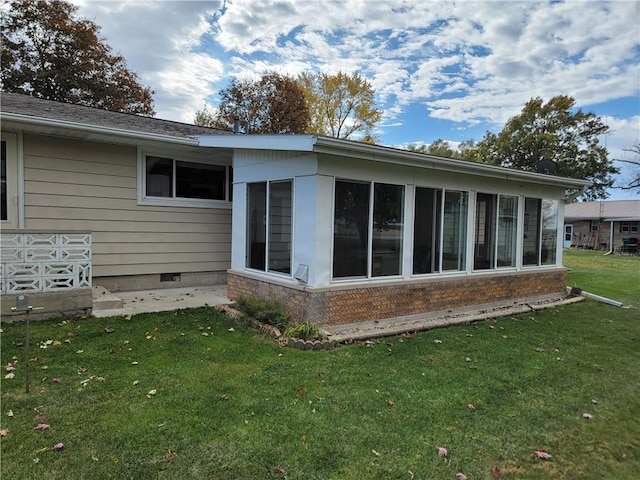 view of side of home featuring a yard